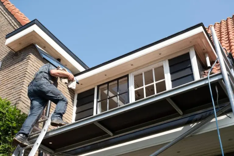 Contractor installing a window on the exterior of a residential home in Southern California