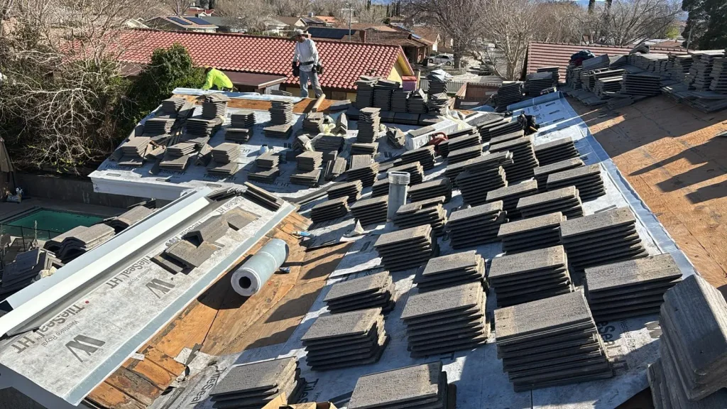 concrete roof tiles stacked across new underlayment during a tile roof replacement in Southern California