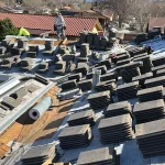 concrete roof tiles stacked across new underlayment during a tile roof replacement in Southern California