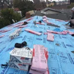 roofing crew installing asphalt shingles over synthetic underlayment on a Los Angeles home
