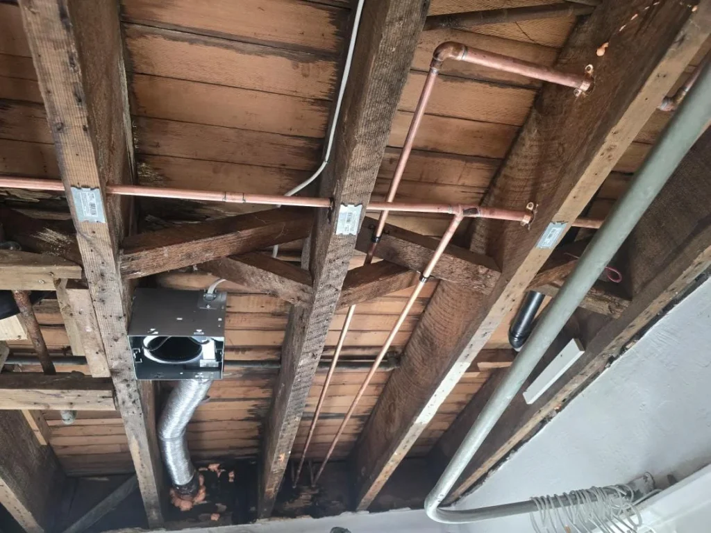 copper water lines running through open ceiling joists during a whole home repipe