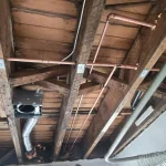 copper water lines running through open ceiling joists during a whole home repipe