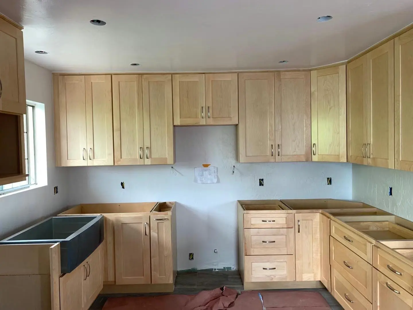 New kitchen cabinets being installed after rough inspection